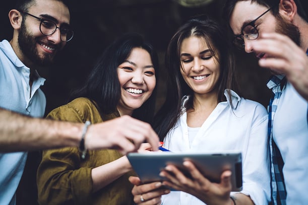 group of people looking at a recognition software