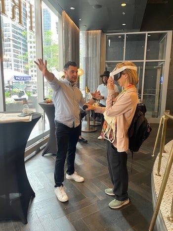 Guests enjoying cocktails and hors d'oeuvres while engaging with MR technology at Francois Frankie in Chicago.