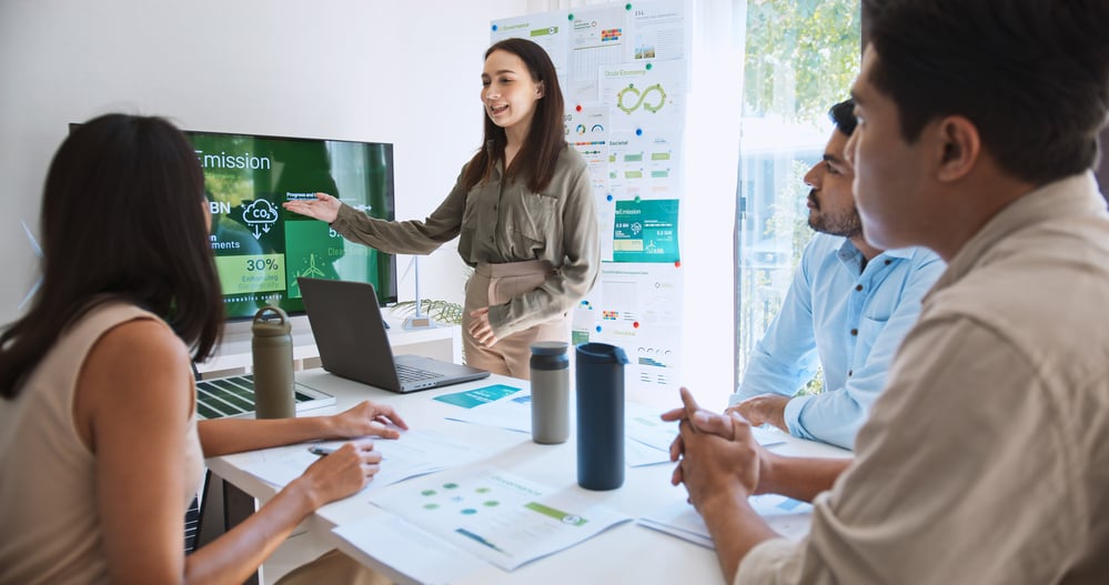 eam of professionals discussing ESG strategies in a meeting room.