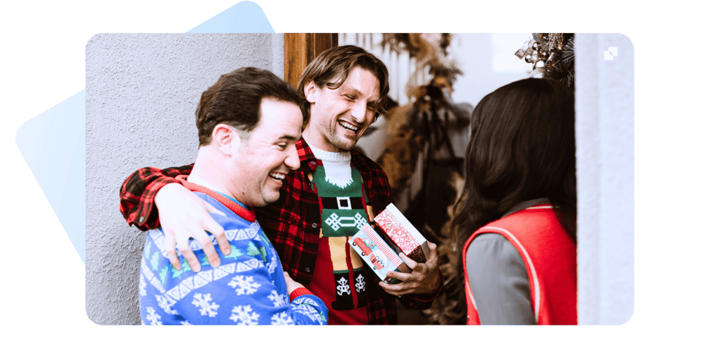 happy people wearing christmas sweaters