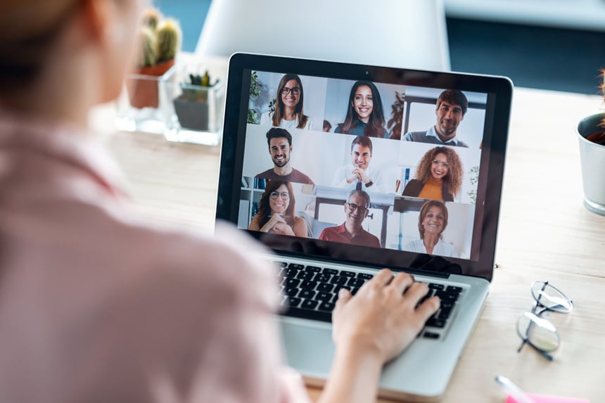 A person engaged in an online meeting with their team, showcasing remote collaboration.