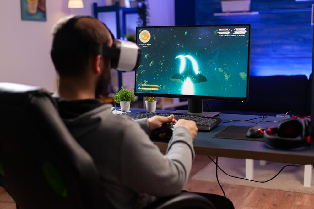 man playing videogames in VR