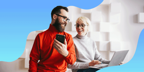 men and woman looking at phone in an office setting