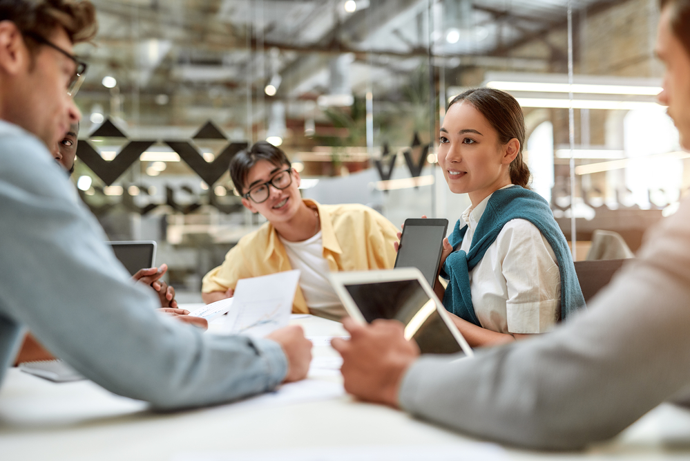 Diverse team brainstorming in a modern office to boost employee engagement.